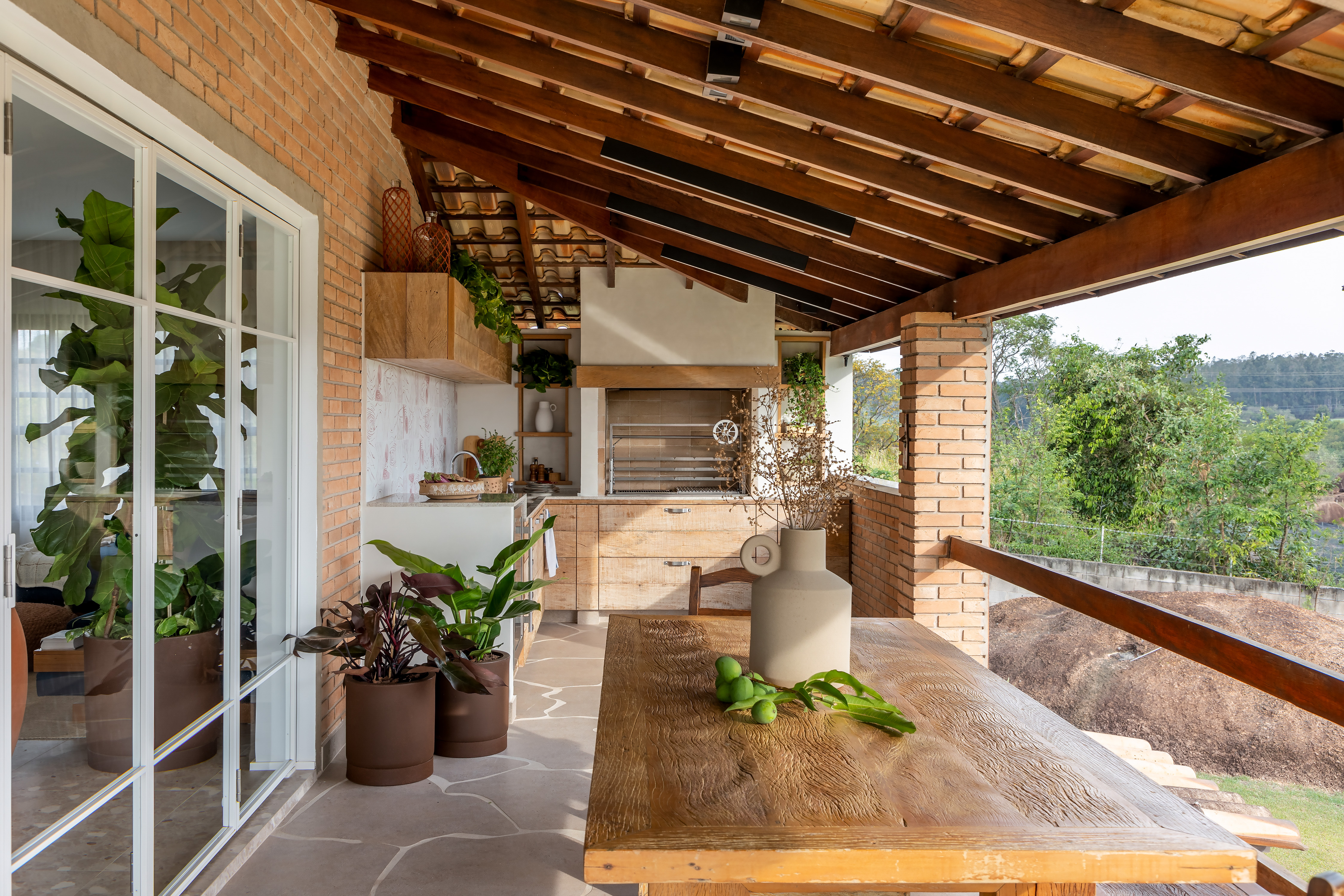 Casa de veraneio se transforma em lar definitivo da família. Projeto de Beatriz Quinelato. Na foto, churrasqueira com floreira e piso orgânico.