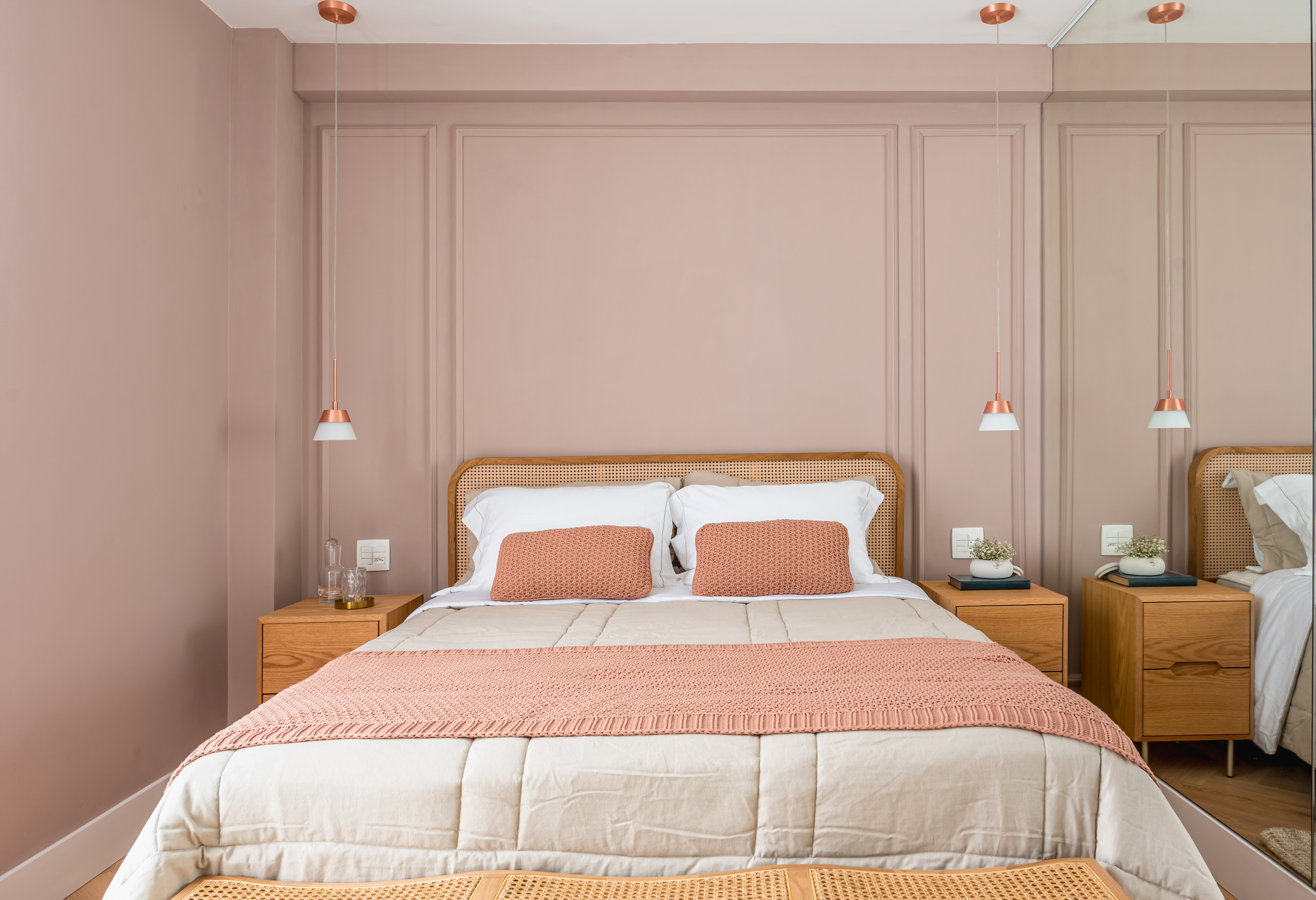 Tons de rosa dão cor e vida para este apartamento de 170 m². Projeto de Paula Müller. Na foto, quarto de casal com parede rosa e cabeceira de palhinha.
